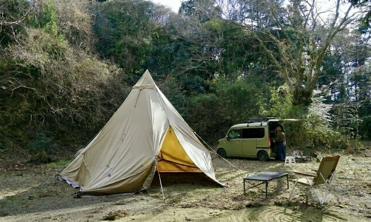 森の中に設営されたティピーテントと軽バン