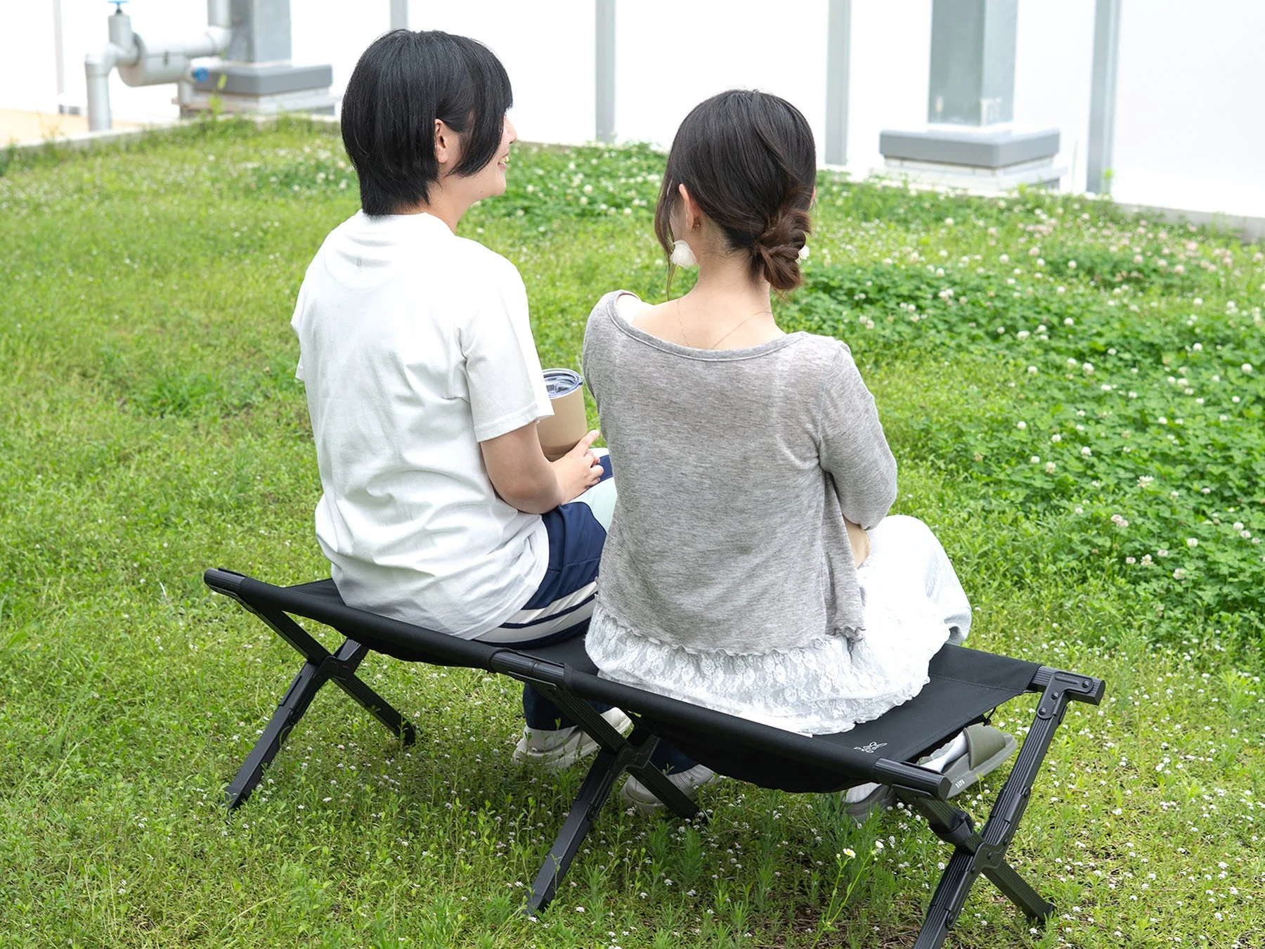 屋外でベンチに座る二人